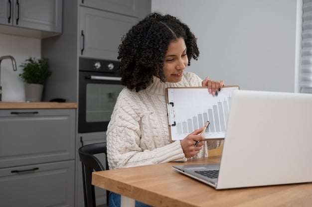 A person working on a laptop at home, with a focus on a spreadsheet showing income and expenses. There are also some bills and receipts scattered around the workspace. The light is soft and warm, suggesting a comfortable home environment.