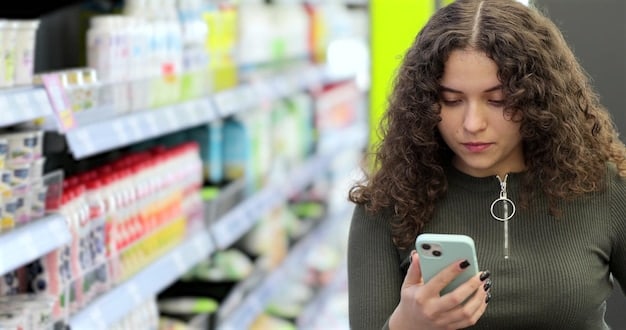 A person comparing prices of groceries in a supermarket using a smartphone app. The grocery items include vegetables, fruits, and canned goods. The background shows other shoppers and shelves filled with various products.