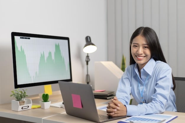 A Filipino businesswoman analyzing investment charts on her laptop, strategizing how to grow her business savings.