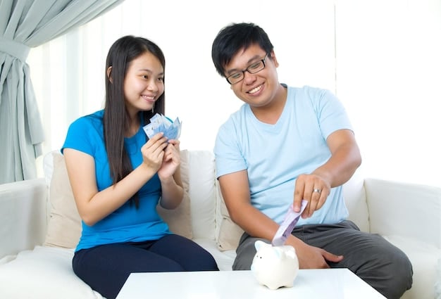 A young Filipino couple happily putting coins into a piggy bank, representing their shared financial goals. The background shows a simple but cozy home.