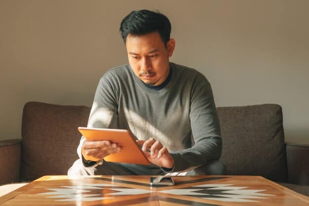 A frustrated Filipino investor looking at a declining graph on his tablet, symbolizing financial loss due to an investment scam. The background is blurred to emphasize his disappointment.