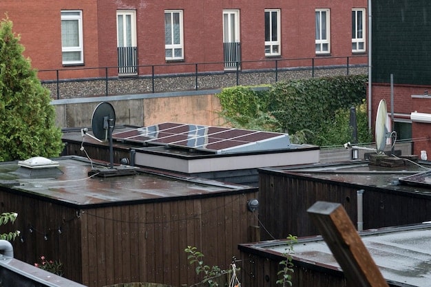 A close-up shot of solar panels installed on a rooftop in an urban setting in the Philippines. The panels are sleek and modern, and the background shows a cityscape with buildings and greenery, emphasizing the integration of solar energy in urban environments.