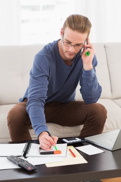 A person meticulously calculating their monthly expenses and income in a notebook, using a calculator, highlighting the importance of budgeting to avoid debt. The scene is set on a wooden desk with a pen and a cup of coffee.