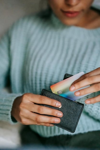A hand placing a credit card into a wallet, symbolizing responsible credit card usage and taking control of one's finances.