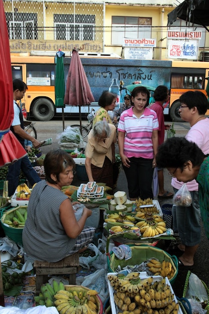A vibrant street food market in Southeast Asia, with various stalls selling affordable and delicious local dishes.
