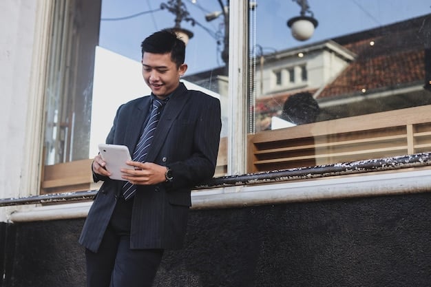 A Filipino investor using a mobile app on their smartphone to check their stock portfolio. The app displays charts and graphs showing the performance of their investments. The person is sitting in a coffee shop, with a relaxed and focused expression.